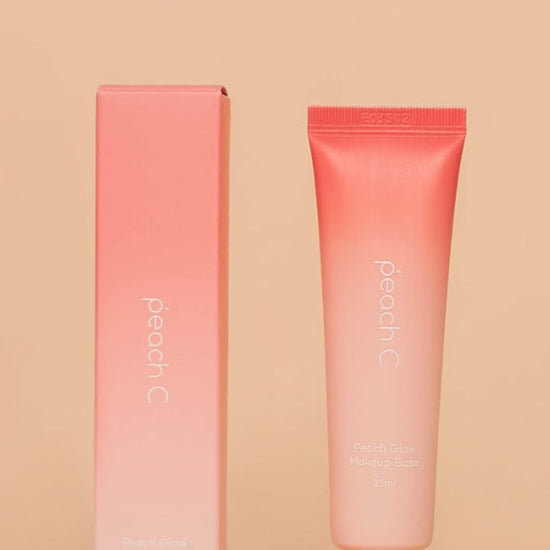 Coral-colored tube and packaging on a beige background