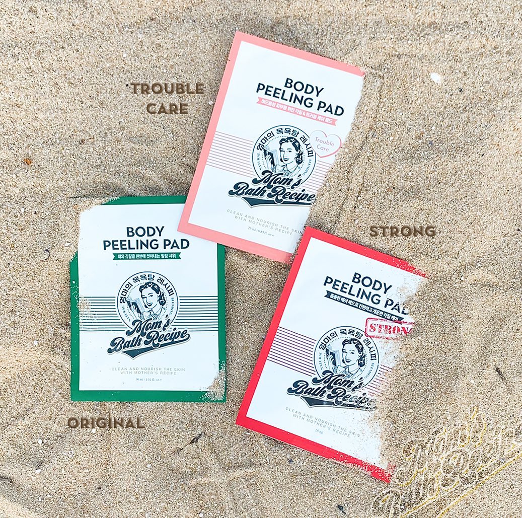 Three 'Mom's Bath Recipe' body peeling pads on sand with labels indicating strength and type.